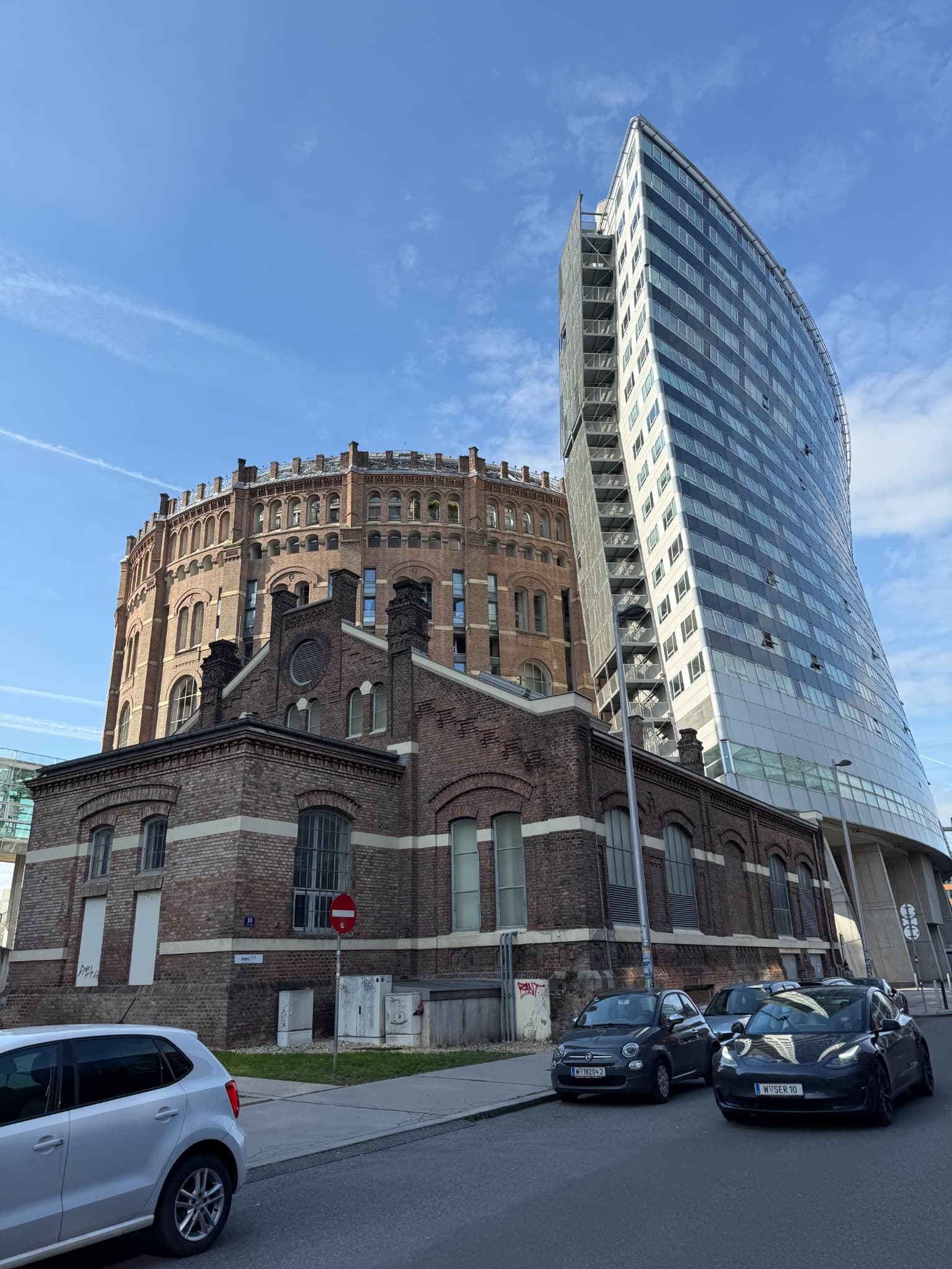 A historic Vienna Gasometer beside contemporary glass architecture